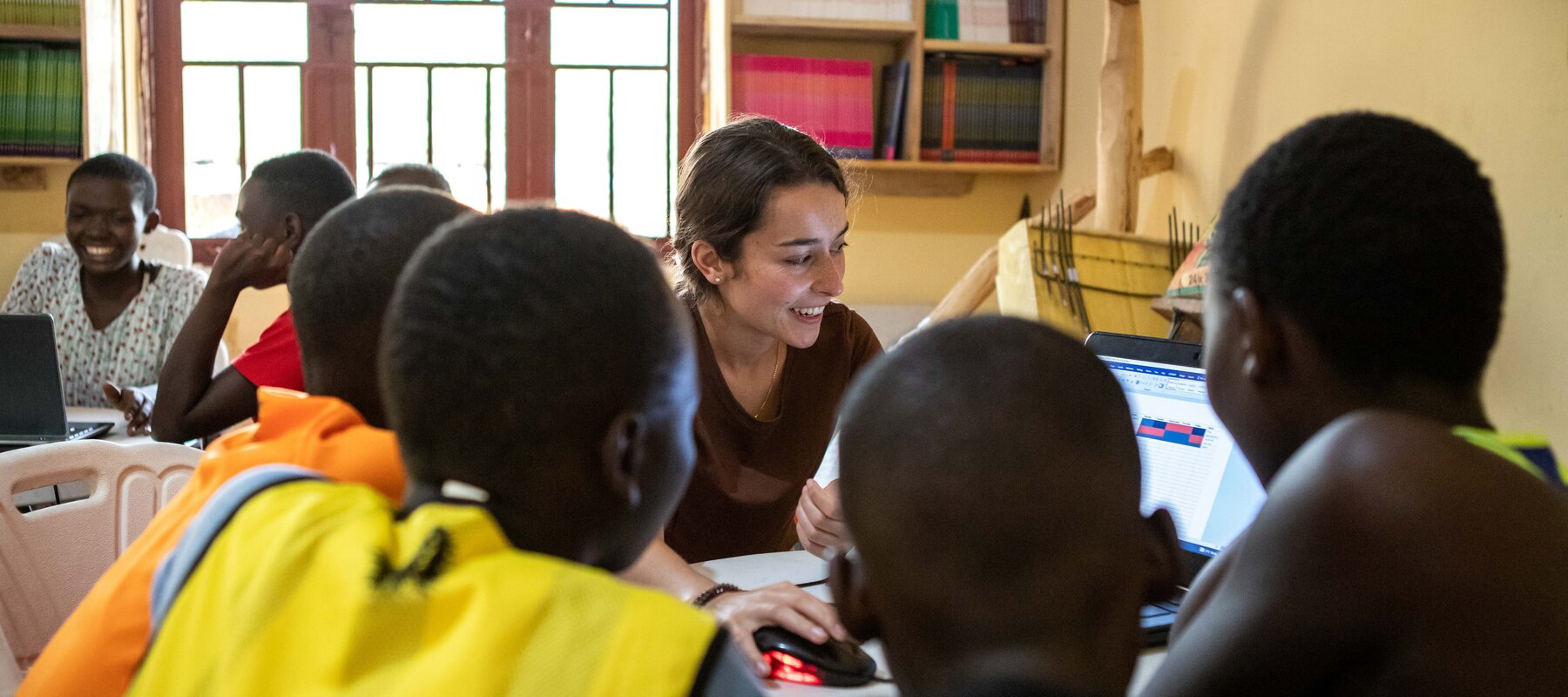 A student works with children as part of an Iacocca International Internship in Uganda