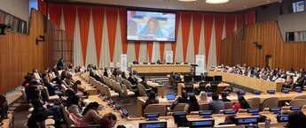 A group of people listening to a speaker at the United Nations headquarters