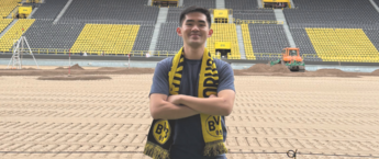 Anh Quan Nguyen standing in a football stadium in Dortmund, Germany