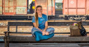 Ashley Pritchard sitting on a bench in Myanmar