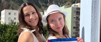 Two women holding a small Spain flag