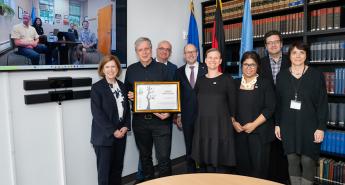 A delegation receiving a certification at the German Mission of the United Nations