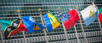 Several flags in front of the United Nations headquarters