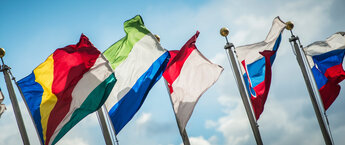Five flags with the sky in the background