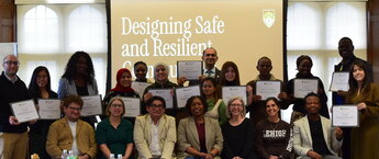 A group of people posing for a photo in front of a screen