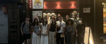 A group of students standing outside a restaurant