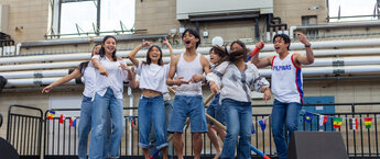 A group of college students performing at an indoor event