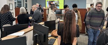 A group of people in an office space for an open house