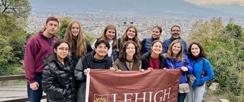 Lehigh students holding a university banner in front of a view of Chile