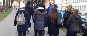 A group of college students walking down a street in Munich, Germany