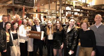 Lehigh University President Joseph Helble with students in a London restaurant