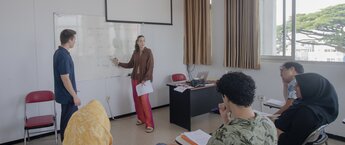 A woman speaking to a classroom of students
