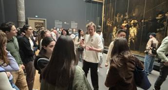 A professor speaking to students at the Rijksmuseum museum in Amsterdam