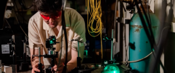 A student using a microscope in a lab