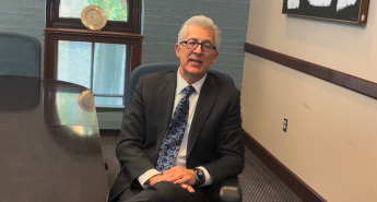 Scott Koerwer sitting in a chair in a conference room