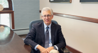 Scott Koerwer sitting in a chair in a conference room