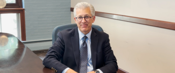 Scott Koerwer sitting in a chair in a conference room