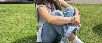 A student sitting in grass