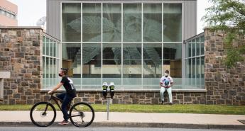 A student rides their bike in front of the STEPS Building at Lehigh University