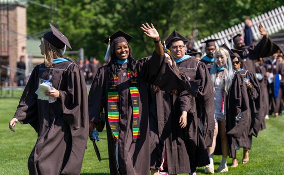 Students walking outside in graduation robes