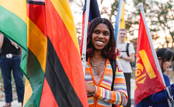 A young woman holding a flag during a parade
