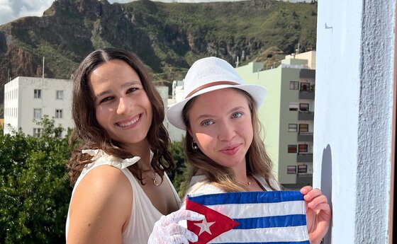 Two women holding a small Spain flag
