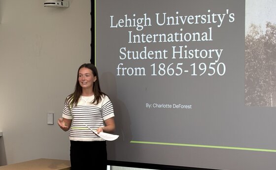 A young woman delivering a Powerpoint presentation
