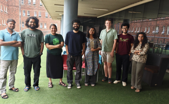 A group of people standing outside a building posing for a photo