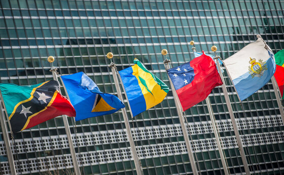Several flags in front of the United Nations headquarters