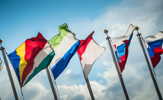 Five flags with the sky in the background