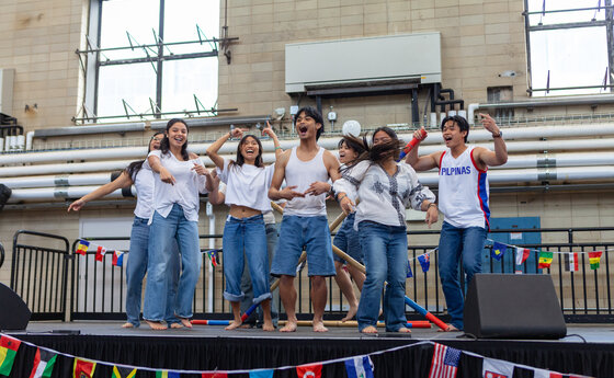A group of college students performing at an indoor event