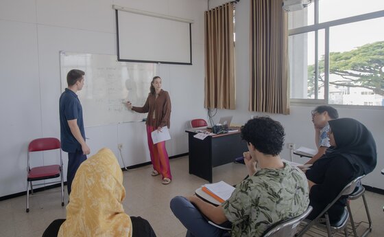 A woman speaking to a classroom of students
