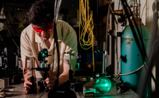 A student using a microscope in a lab