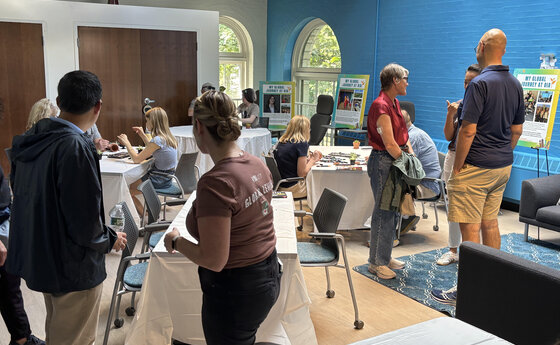 A group of people gathered in a community space with tables and chairs