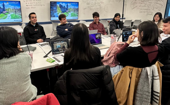 A group of students sitting at a table and working together