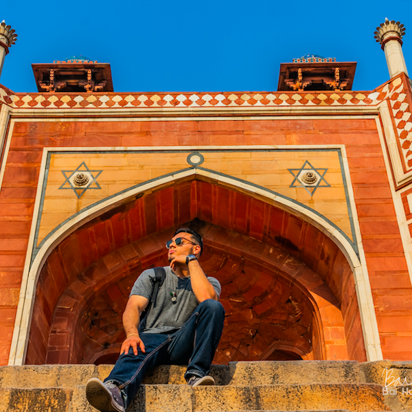 A man sitting on a set of stairs in India