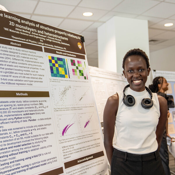A young woman stands in front of an informational display