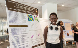 A young woman standing in front of an informational display