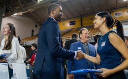 People shaking hands at a career expo