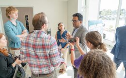 A group of people speaking in a well-lit room