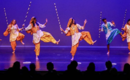 Several dancers performing a Bhangra dance