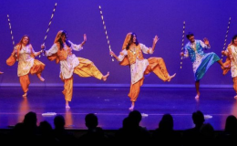 Several dancers performing a Bhangra dance