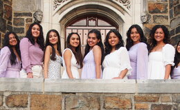 Several Lehigh students standing in front of the door to a building, smiling for the camera