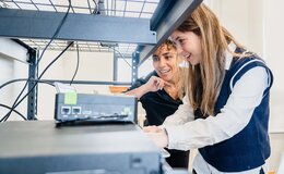 Two people using equipment in a lab