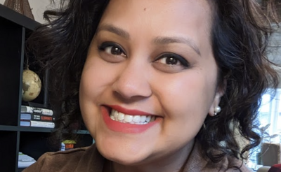 Nur-e Rahman Freedman in a grey blazer and a black shirt